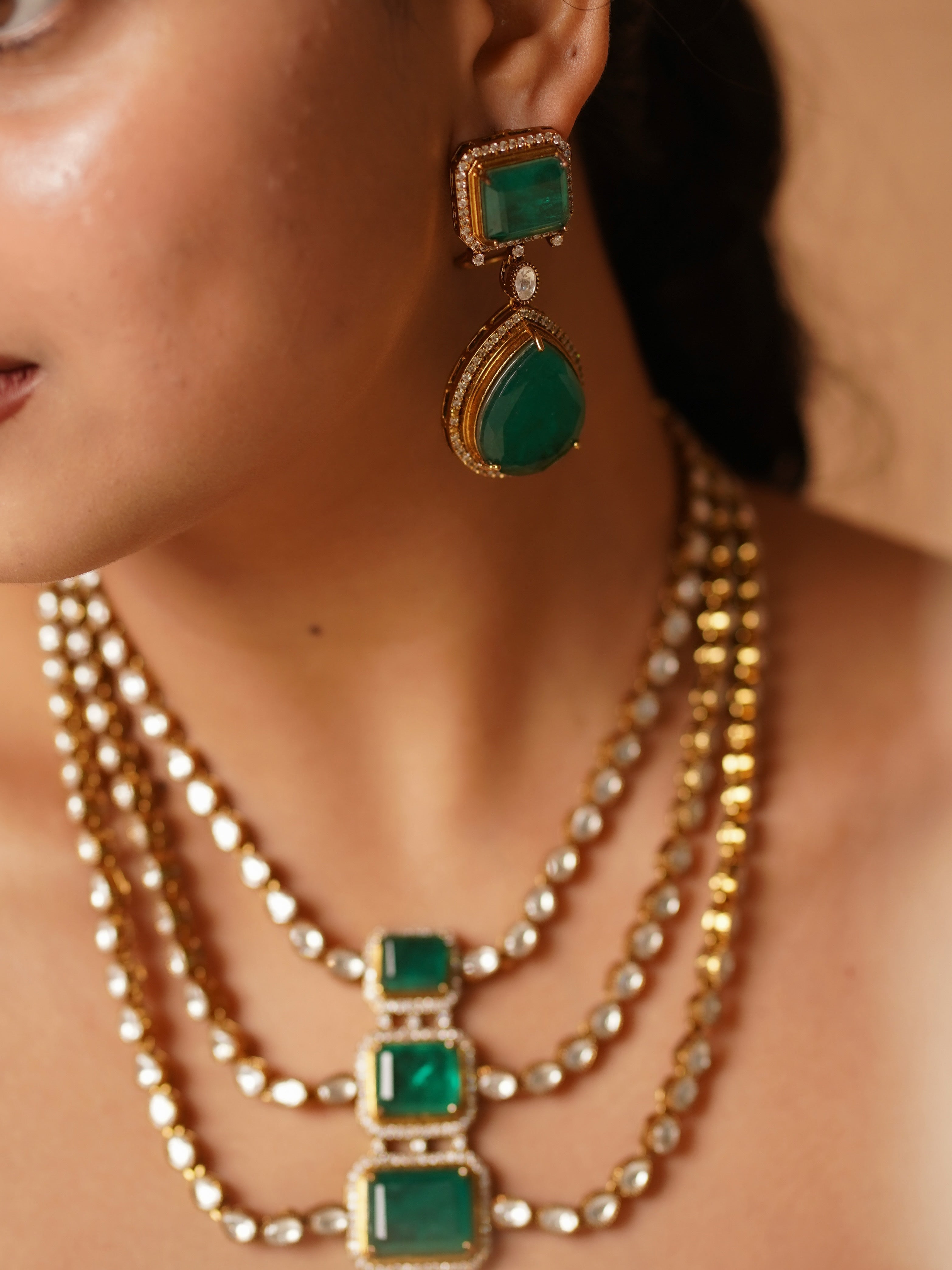Close-up of emerald Victorian necklace showcasing layered structure and green stones